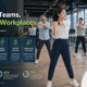 Office employees participating in a workplace group workout class in a modern corporate wellness environment
